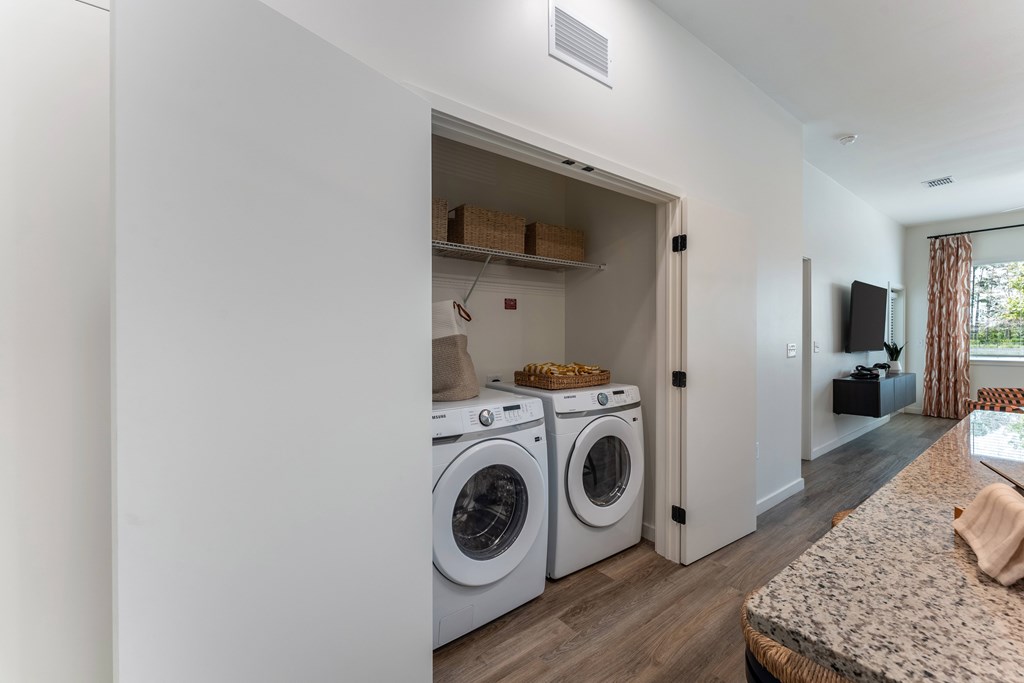 A laundry room with a washer and dryer in unit.