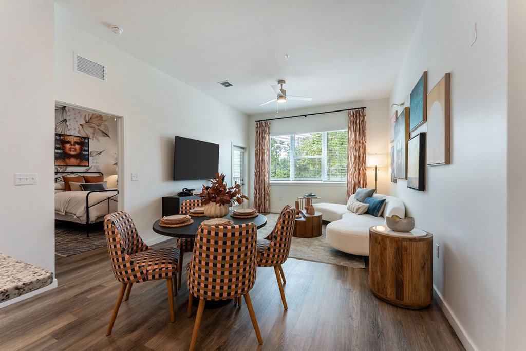 A modern dining room with a wooden table and chairs.