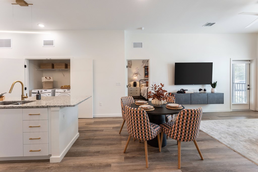 A modern kitchen with a dining table set for four.