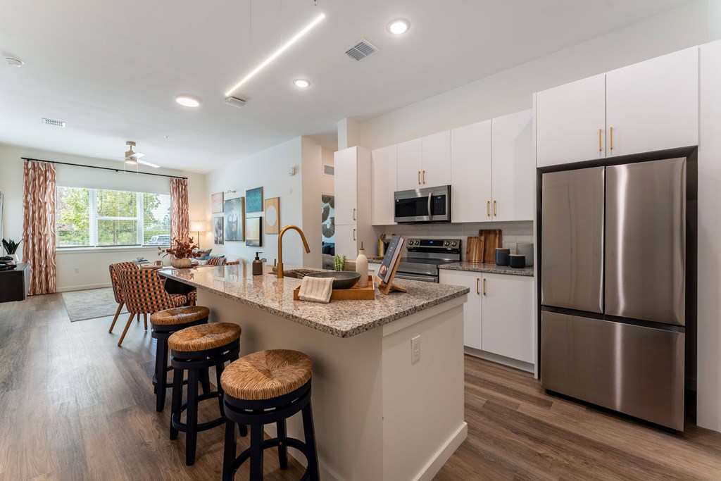 A kitchen with a bar area and stools.