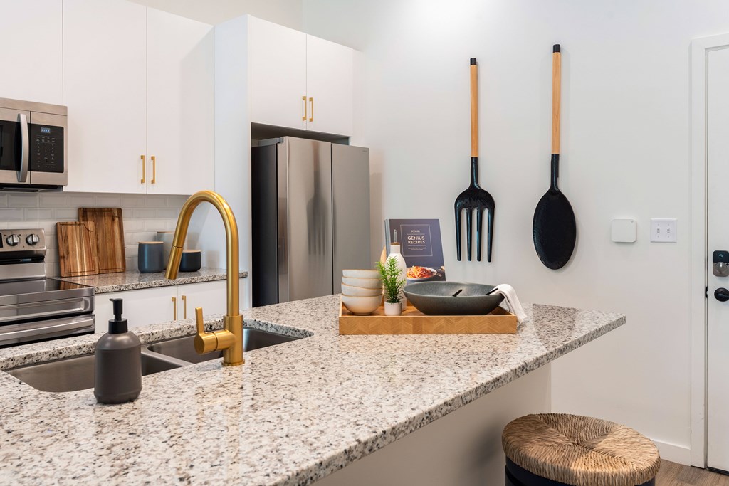 A kitchen with a granite countertop and a sink.