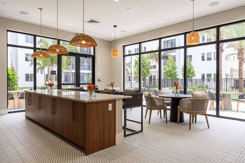 A kitchen with a table and chairs in front of a window.