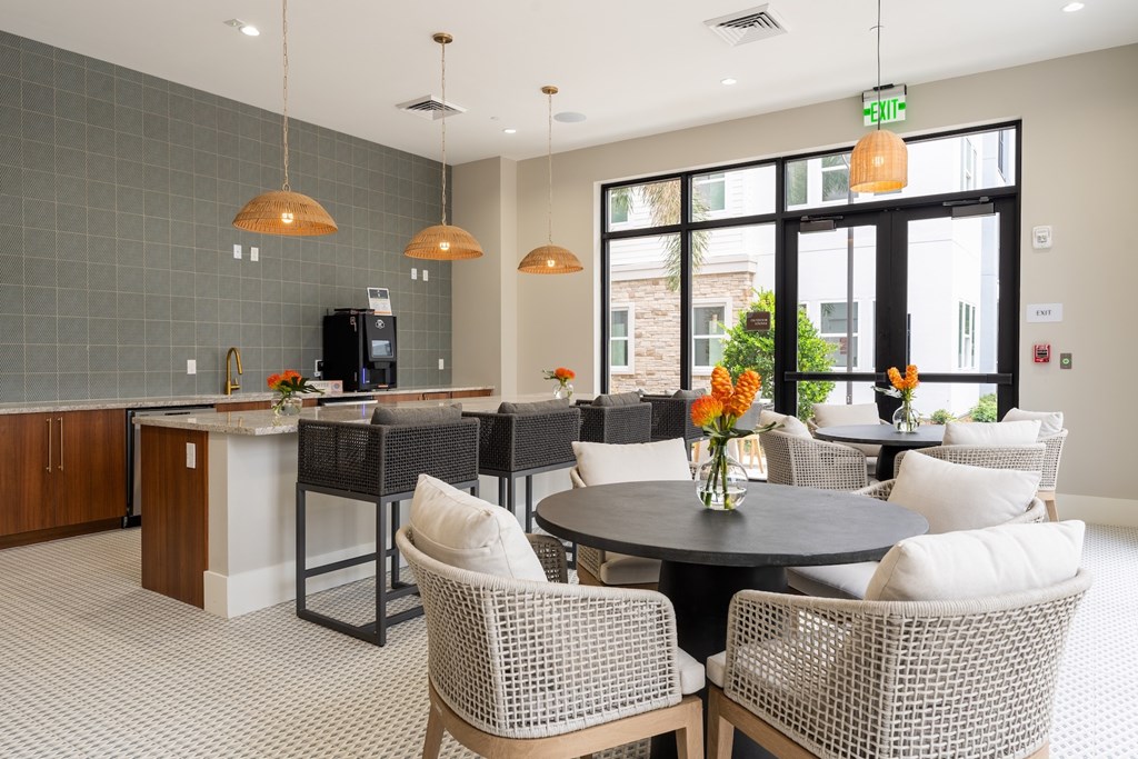 A modern dining area with a round table and chairs.