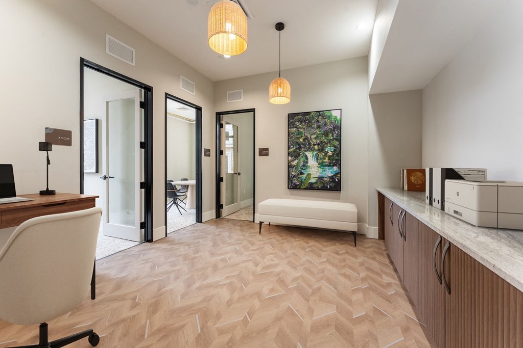 A room with a wooden floor and a white chair.