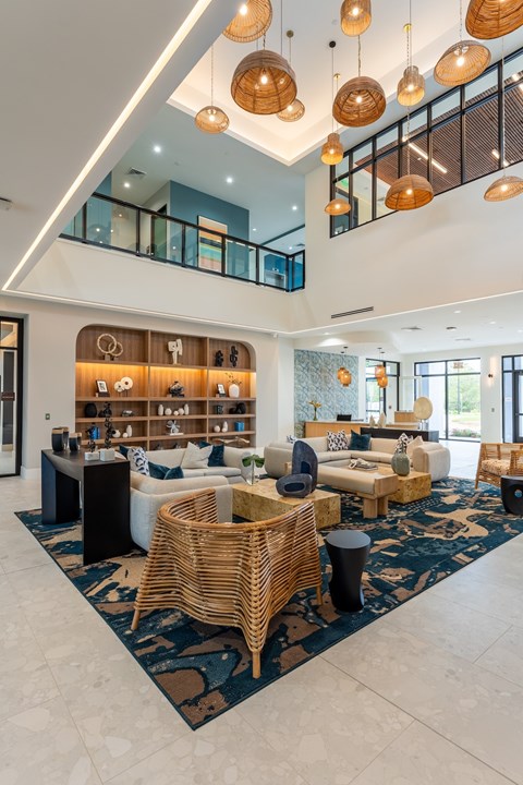 A modern living room with a white sofa set and a wooden coffee table.