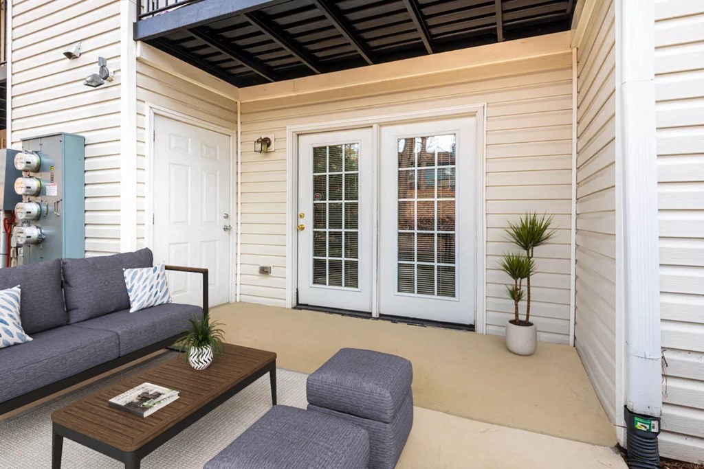 a patio with a couch and a coffee table