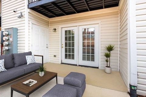 a patio with a couch and a coffee table