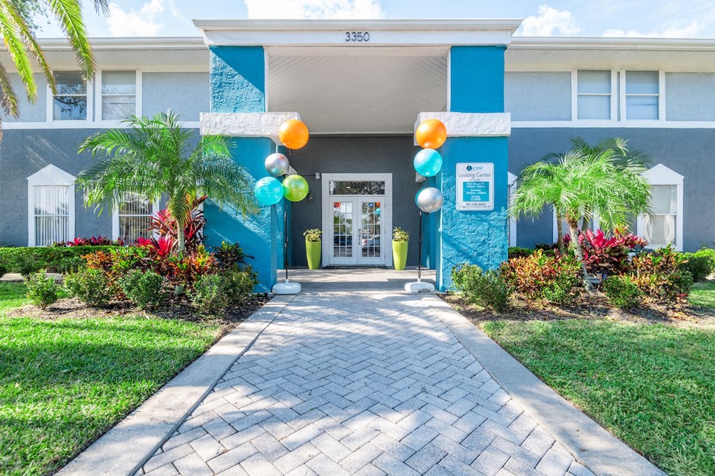 a blue building with balloons in front of it