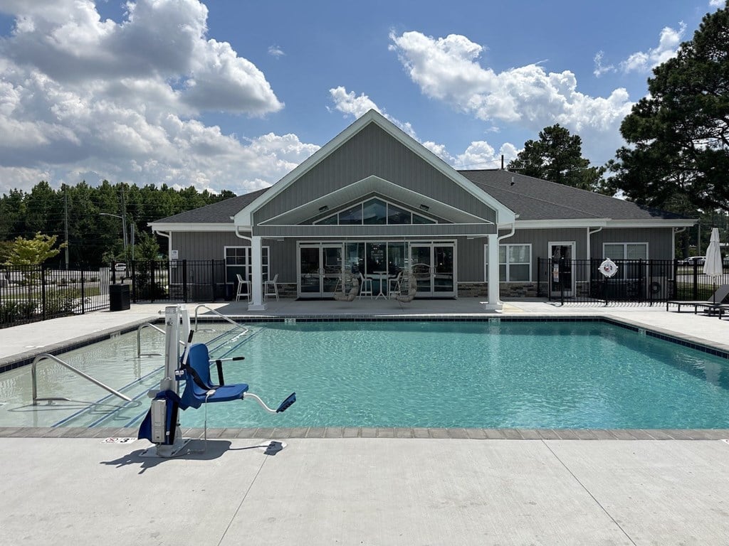 the pool is in front of a house