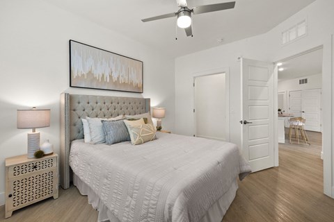 a bedroom with a bed and a ceiling fan