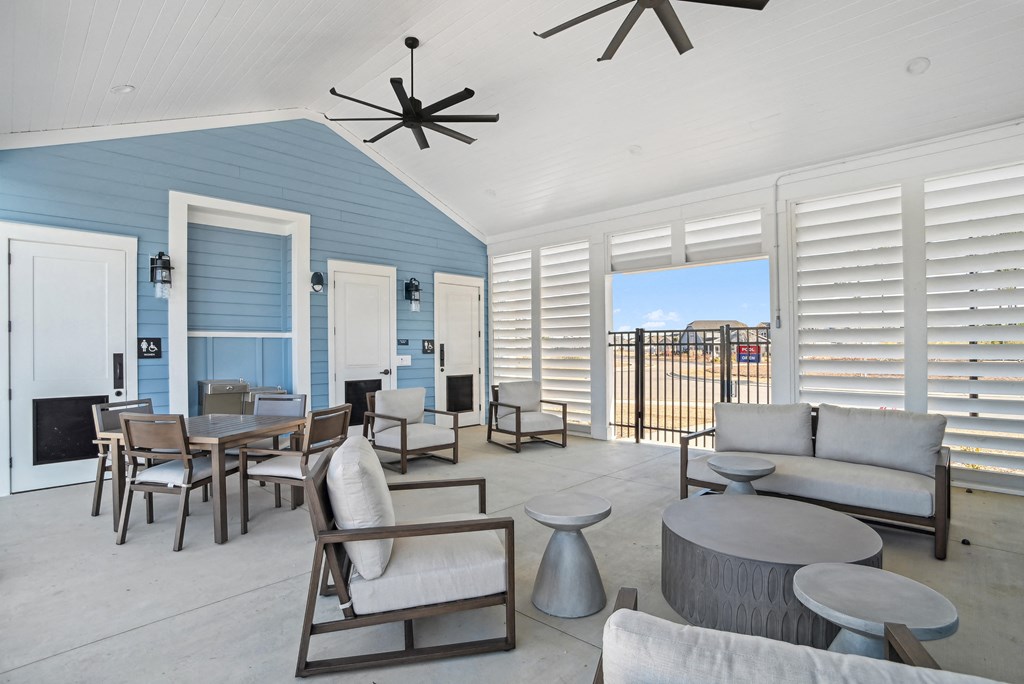 An outside patio with a pool and patio furniture at 15 at Heron apartments in Longs, SC.