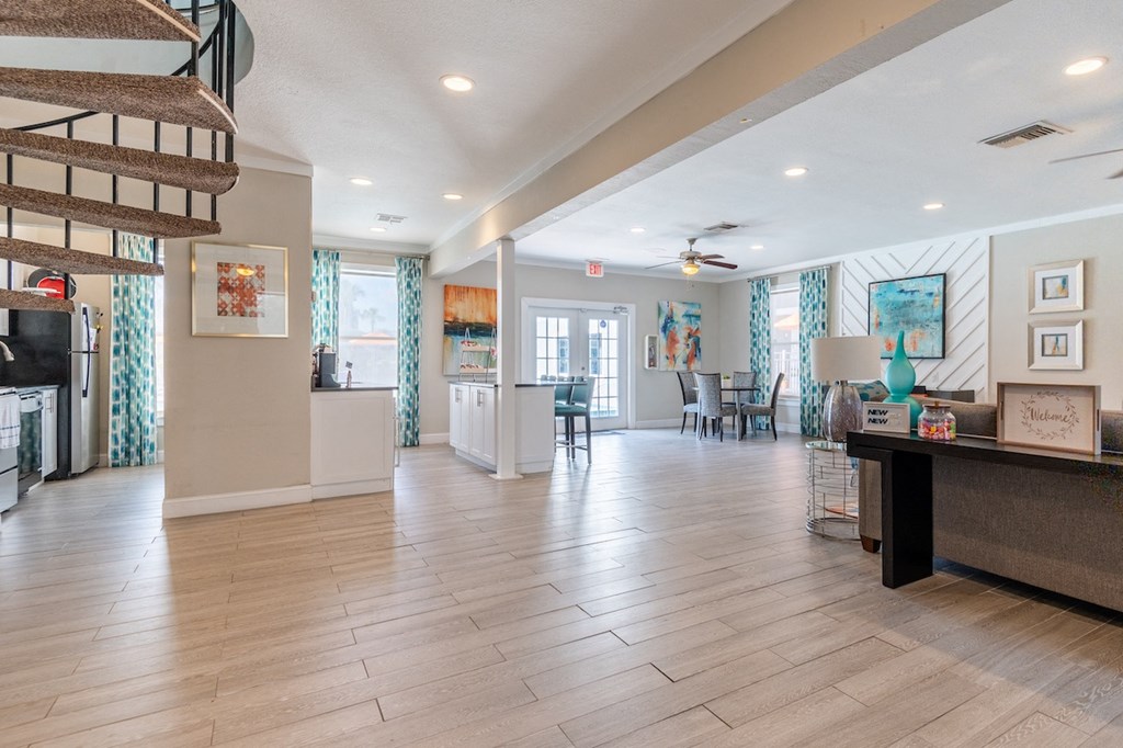 a resident clubhouse with a staircase leading up to the second floor