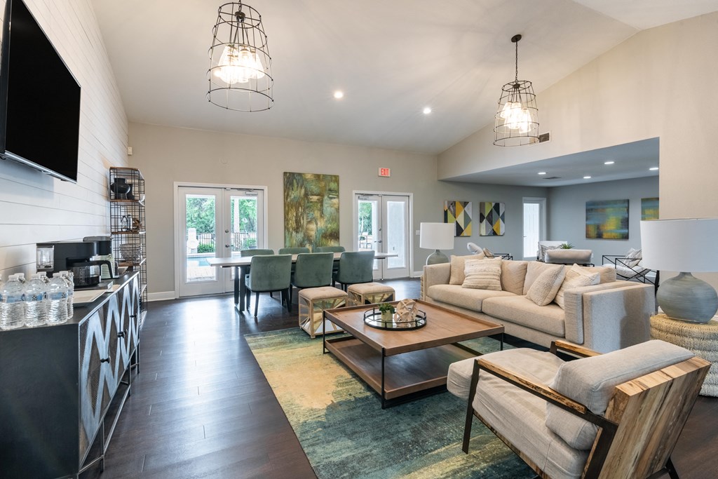 a living room with couches and chairs and a table