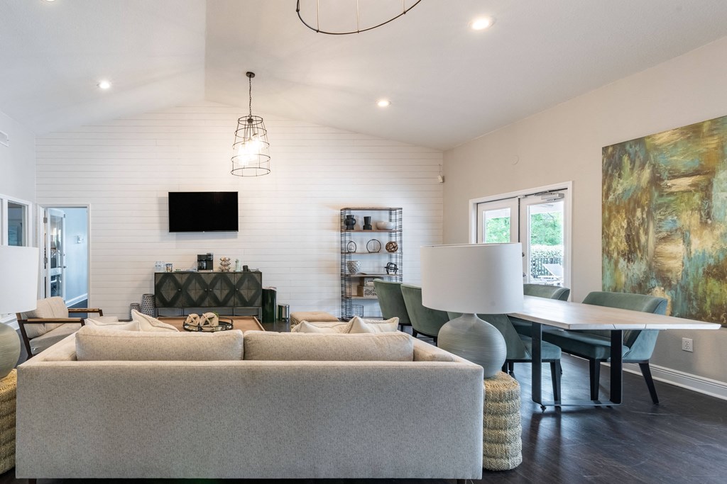 a living room with a couch and a dining table