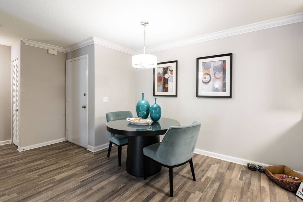 a dining room with a table and chairs and a chandelier