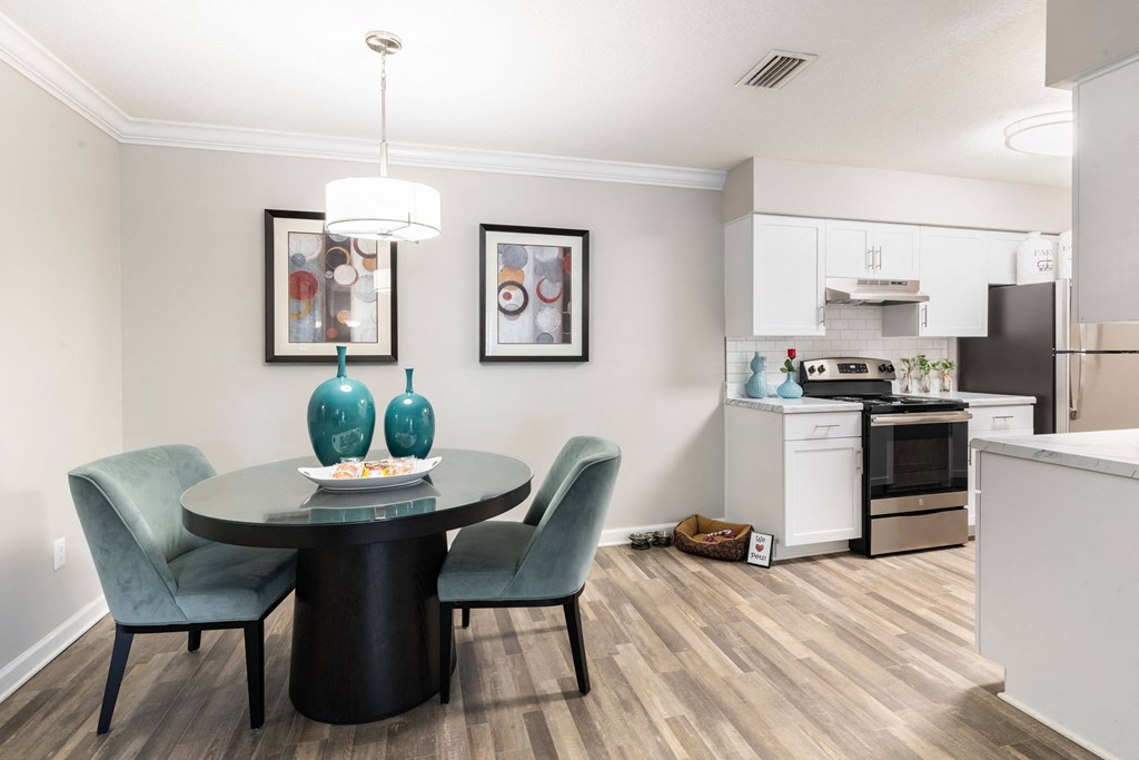 an open kitchen and dining room with a table and chairs