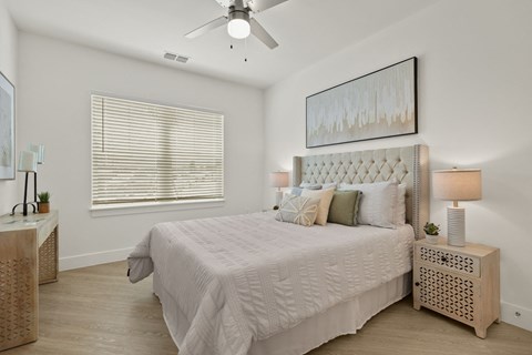 a bedroom with a bed and a ceiling fan