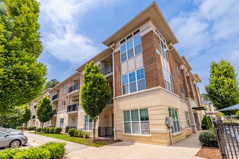 A modern apartment building with a mix of brick and siding exterior.