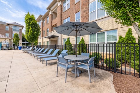 A row of chairs and tables are set up on a patio.