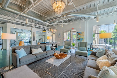 A spacious living room with a grey sofa set and a large coffee table.