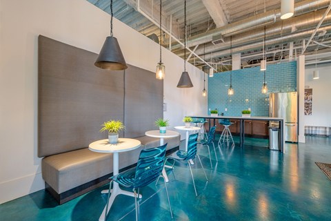 A room with a blue floor and a white table with chairs.