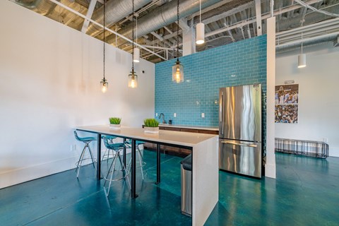 A kitchen area with a table and chairs.