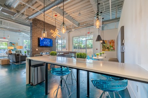 A modern office space with a long table and chairs.