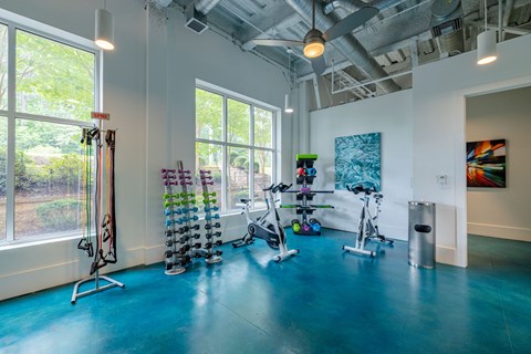 A room with exercise equipment and a window.