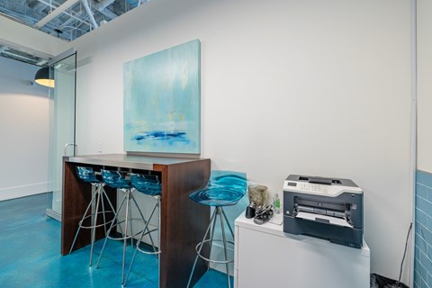 A room with a bar and a painting on the wall.