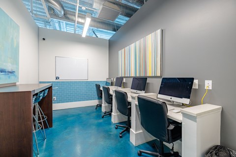 A room with blue flooring and a whiteboard on the wall.