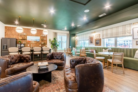 A living room with brown leather couches and a black coffee table.