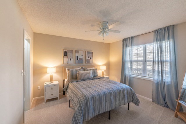 a bedroom with a bed and a ceiling fan