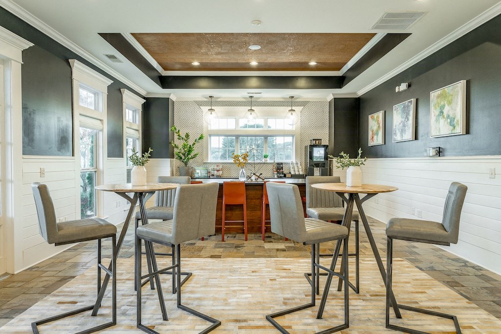 a bar area with high stools and tables