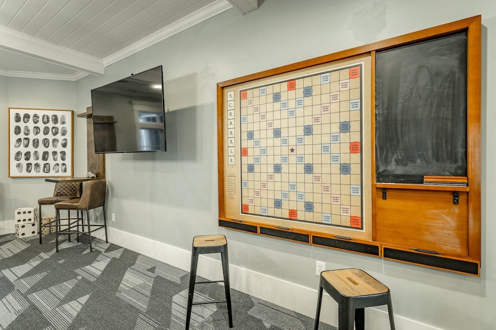 a game board and stools in front of a blackboard