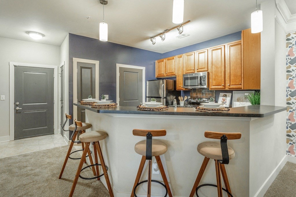 a kitchen with a breakfast bar and stools