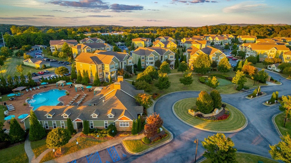 an aerial view of a neighborhood with houses and a swimming pool