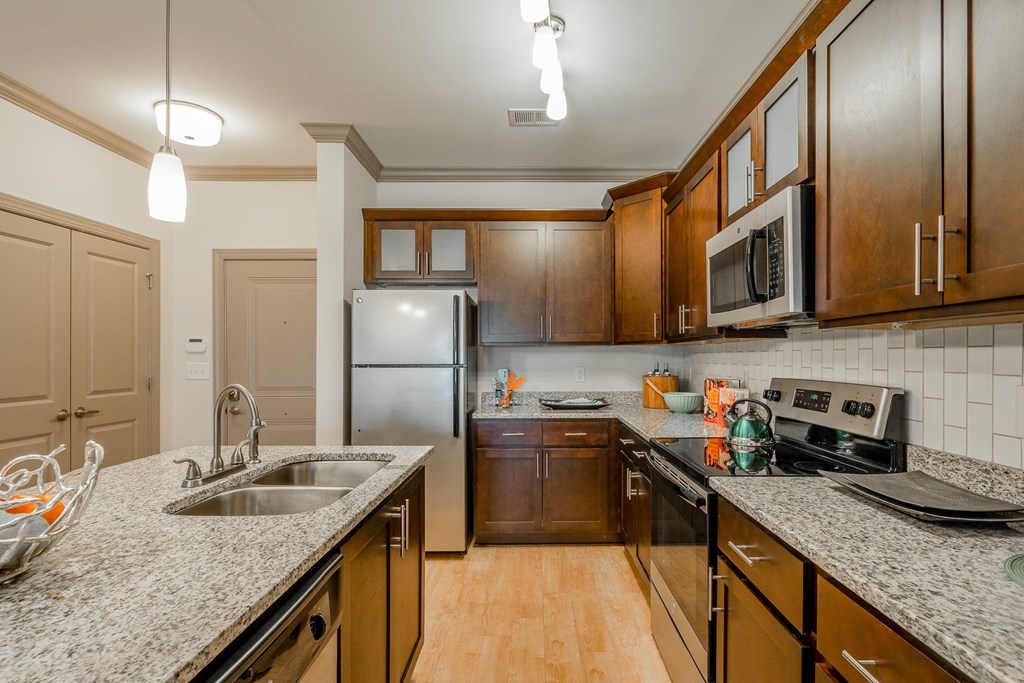 a kitchen with granite counter tops and stainless steel appliances