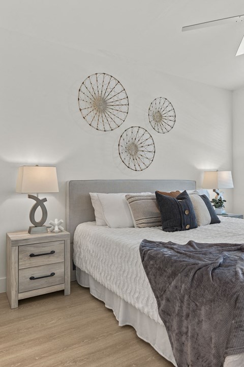 a bedroom with a bed and three clocks on the wall