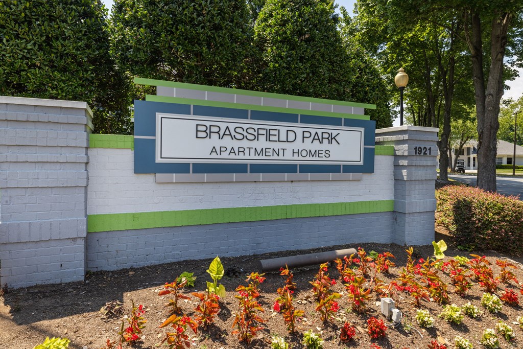 the sign apartment homes in front of a brick wall