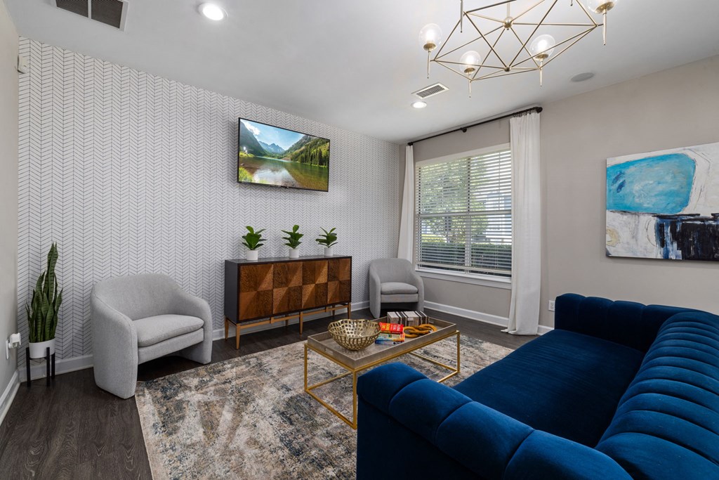 a living room with a blue couch and two chairs