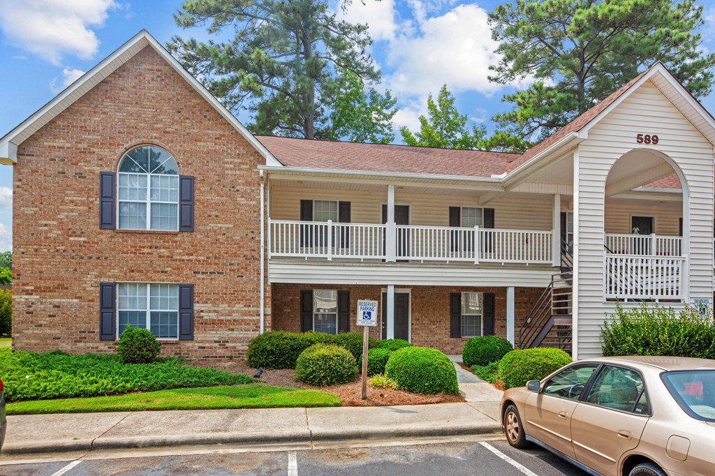 a car parked in front of an apartment building