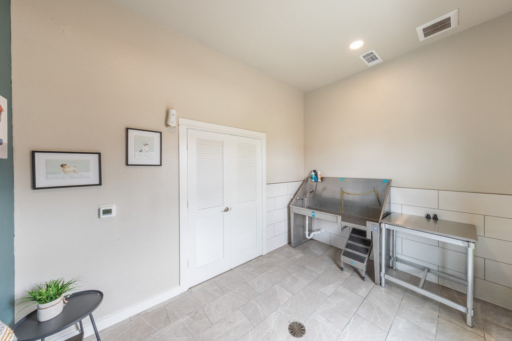 a kitchen with a stove and a sink and a door