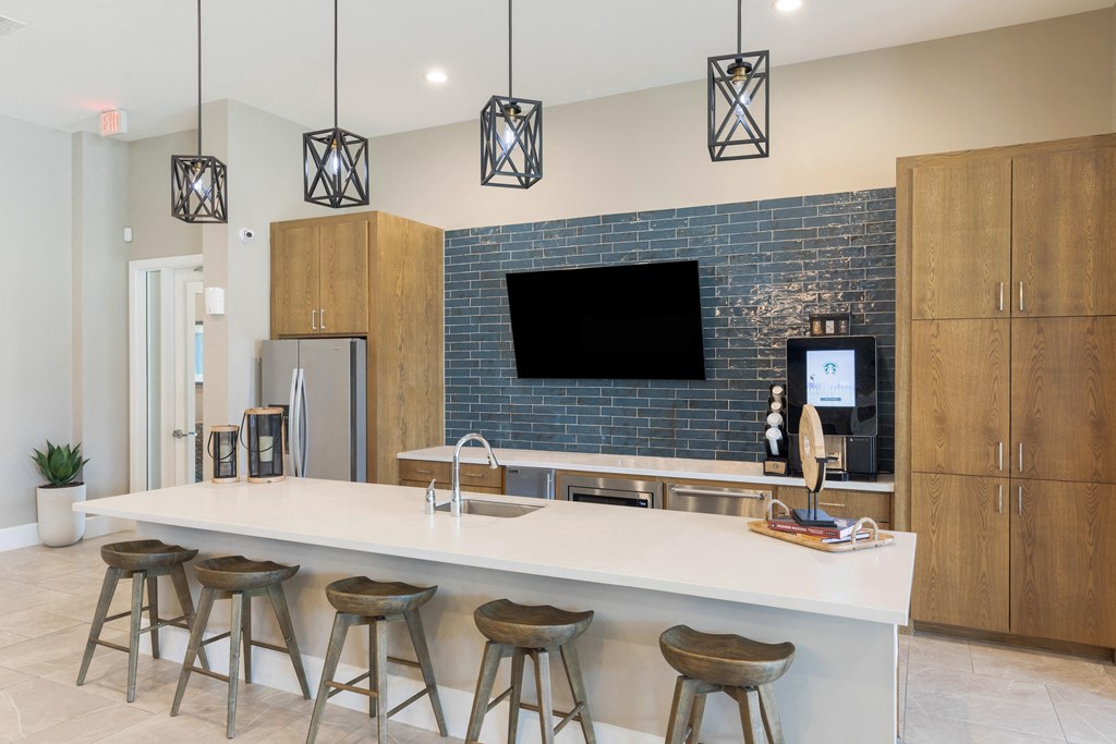 a kitchen with a large island with four stools