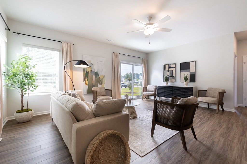 a living room with a couch and a chair and a table