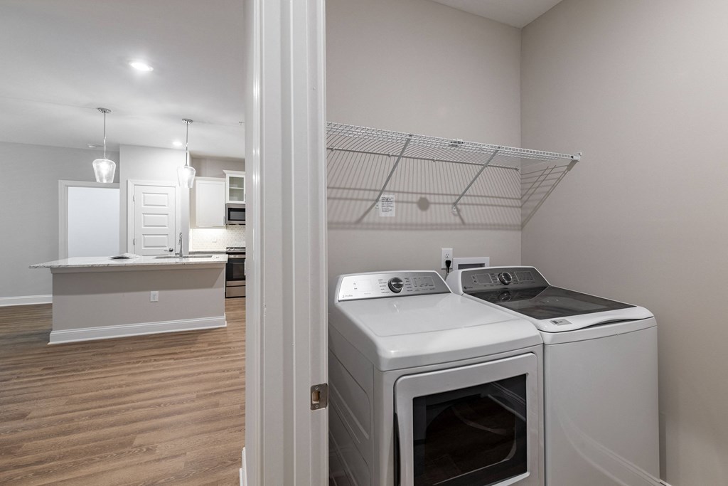 a washer and dryer in a laundry room with a kitchen