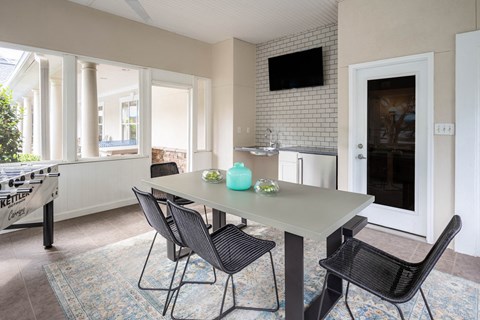 a dining room and kitchen with a table and chairs
