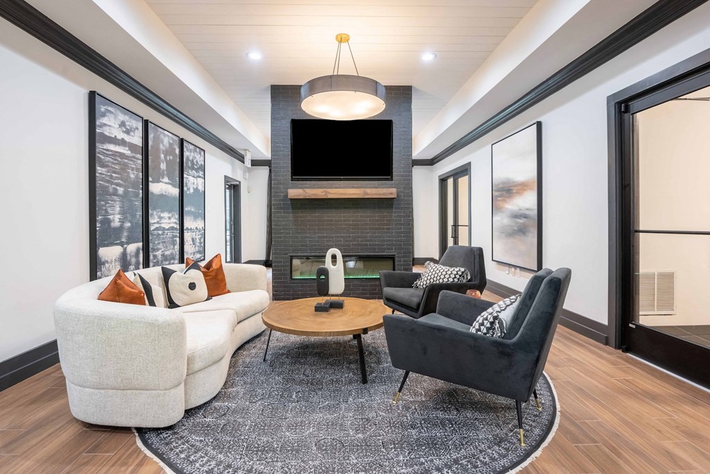 a living room with couches and chairs and a television