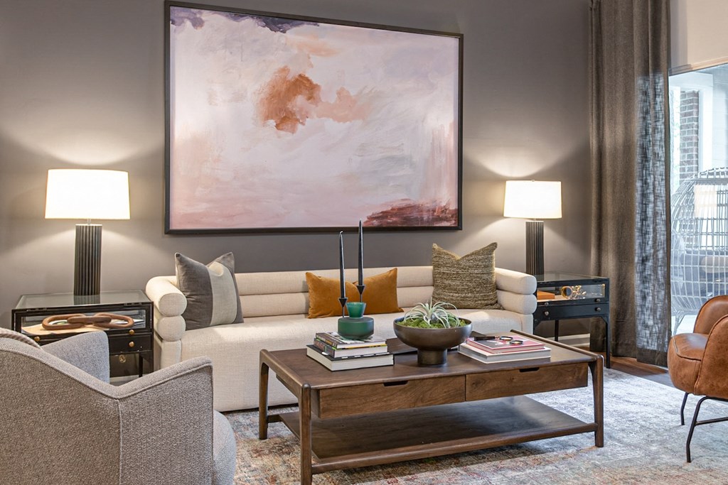 a living room with a couch and chairs and a coffee table