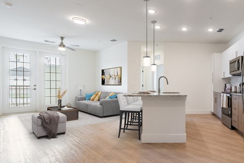 a living room with a kitchen and a couch