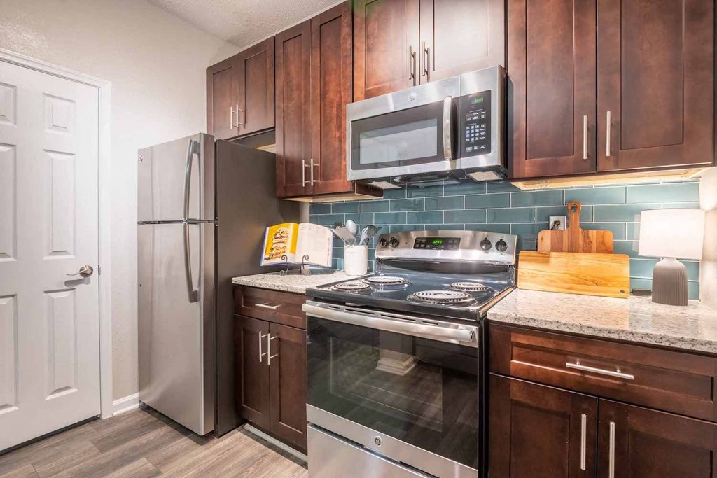 a kitchen with stainless steel appliances and wooden cabinets